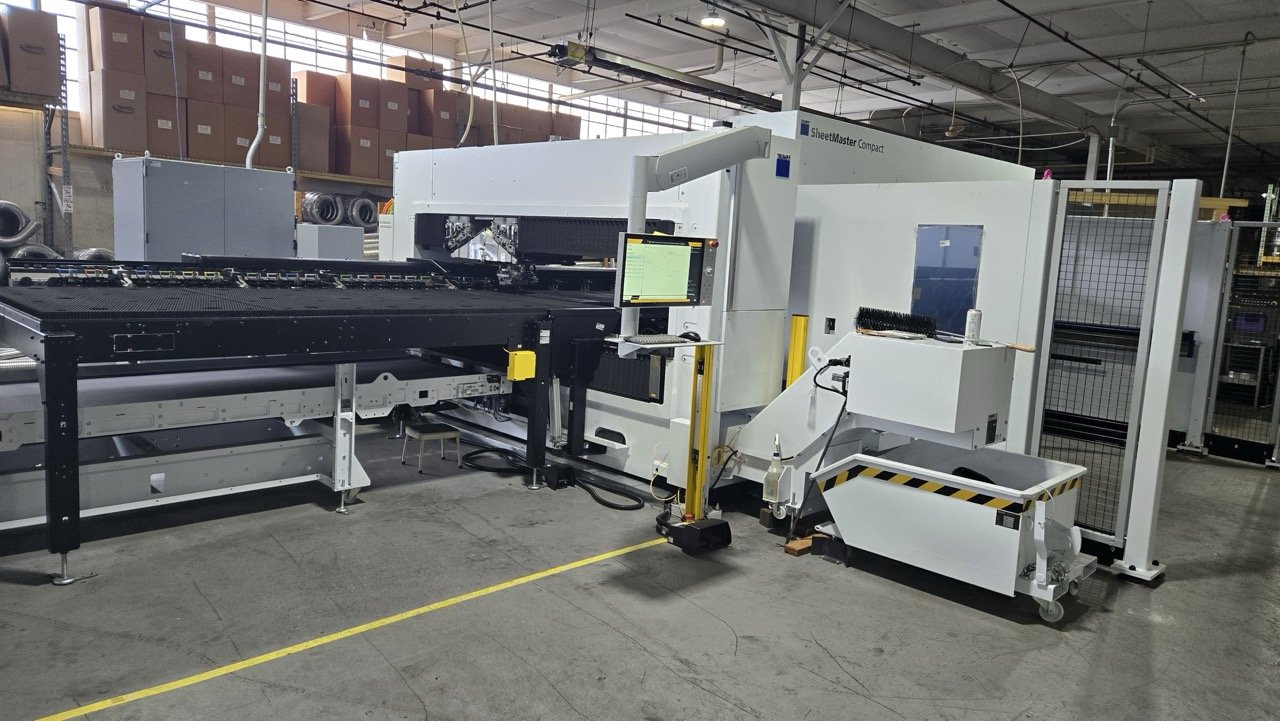 Sheet metal processing machine in industrial warehouse