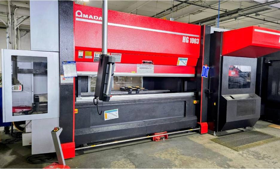 Red industrial machine in a factory setting.