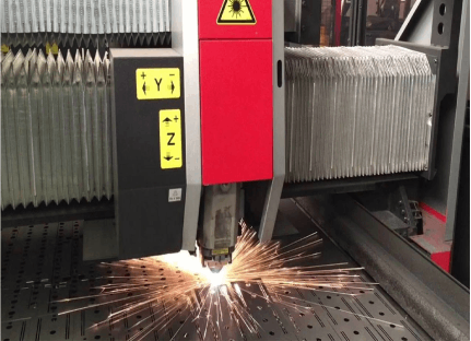 Laser cutting machine processing metal sheet with sparks